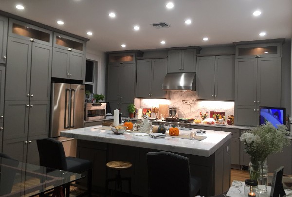 Kitchen remodel with gray shaker cabinets and marble island