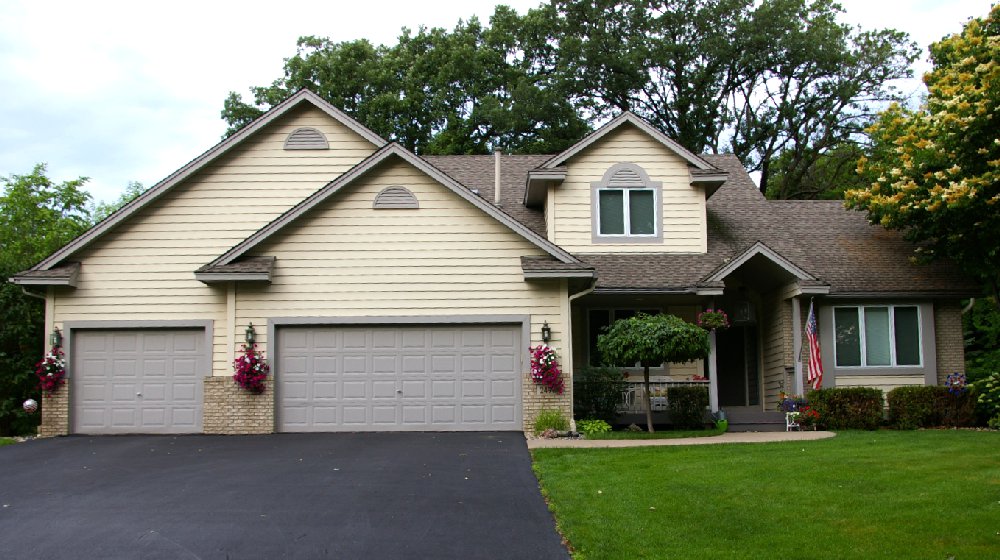 Home with new vinyl siding and brick accents
