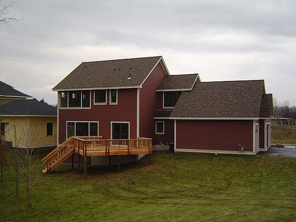 Cedar deck and stairs on a new red-sided home