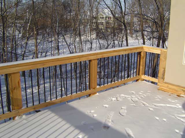 Cedar railing with black balusters on a new winter build