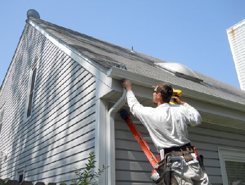 Seamless gutter being installed