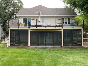 Upper deck over a screened lower level facing the yard